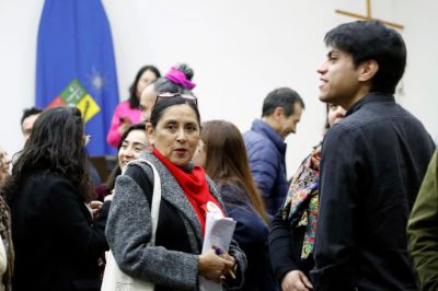 Personas paradas, conversando y sonriendo en el taller